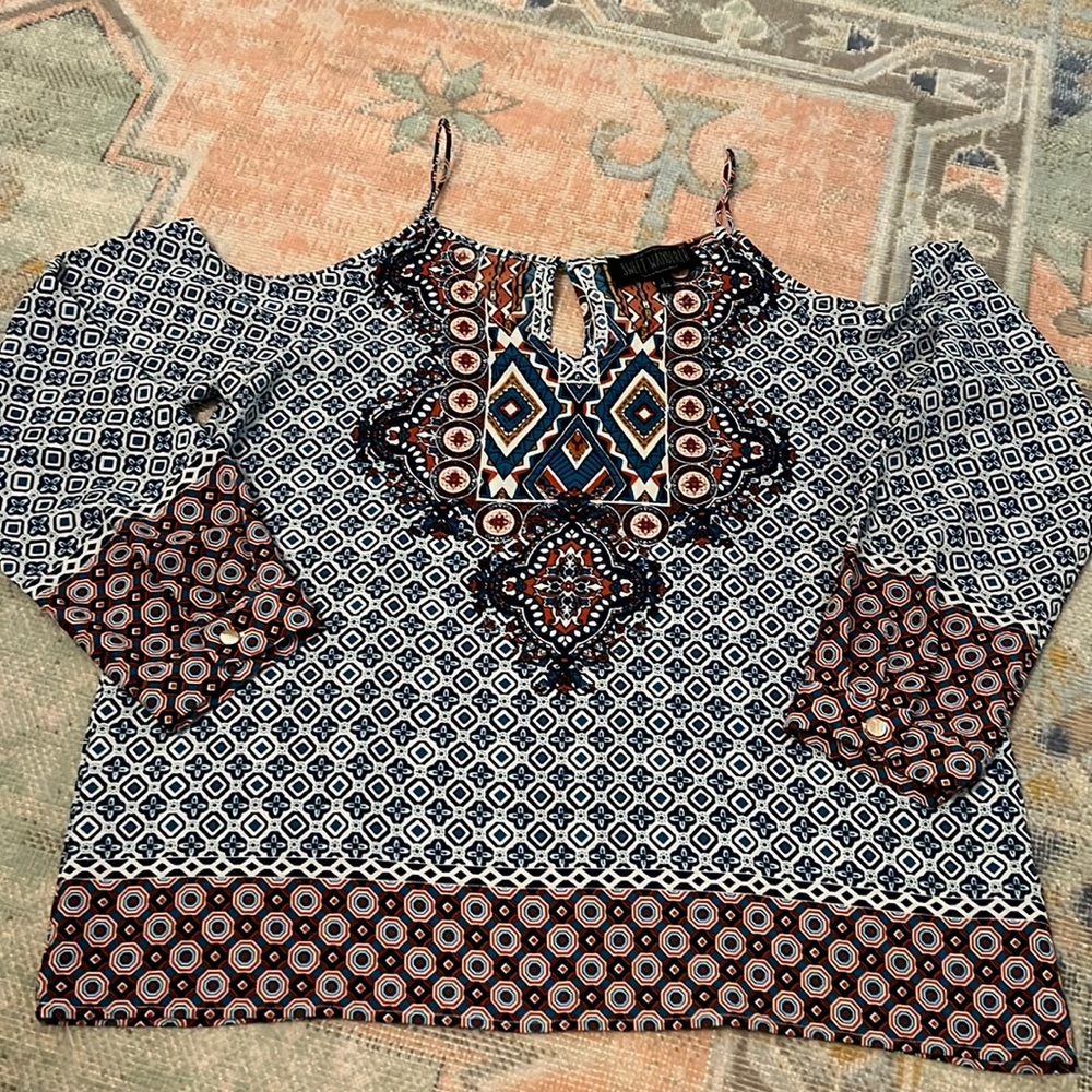 Boutique style long sleeve top. Shoulders cut out with spaghetti strap detail.